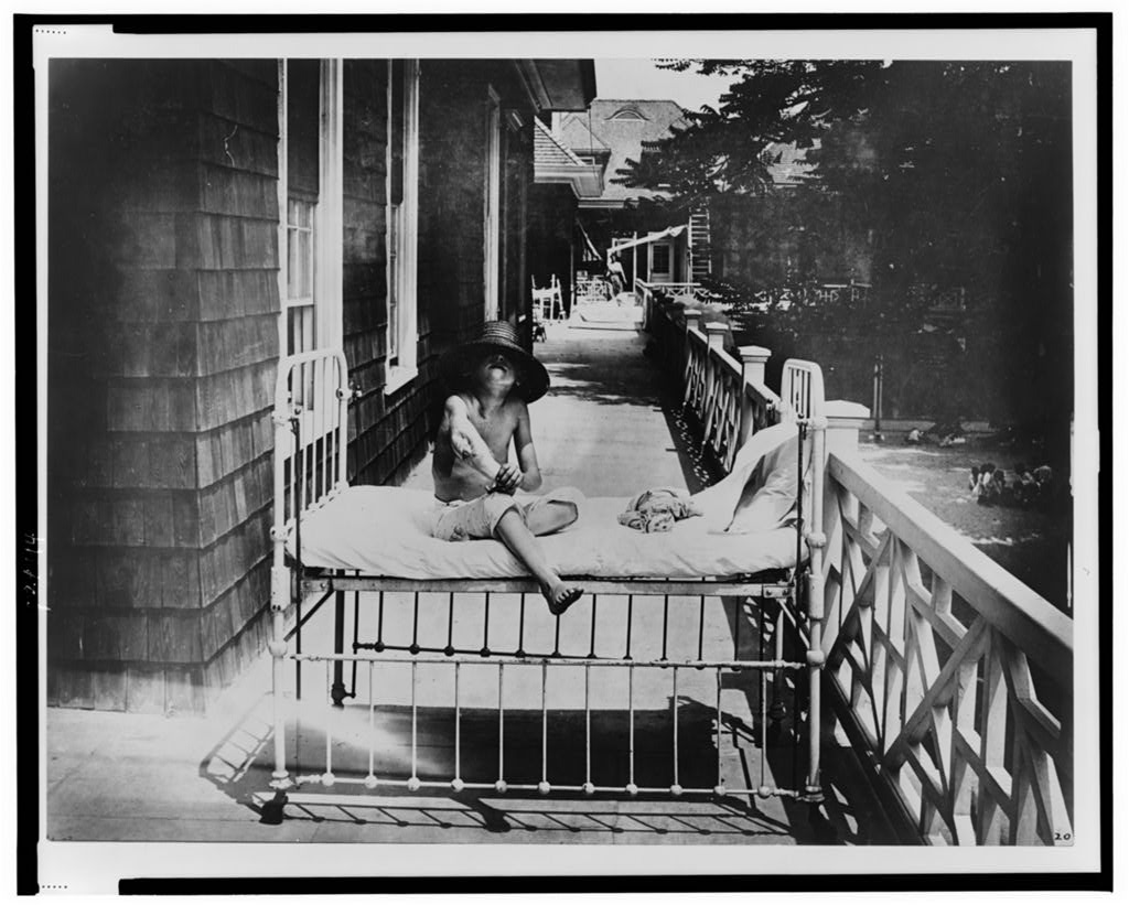 [Tubercular child seated on bed, outdoors, at Sea Breeze Hospital, Coney Island, New York] [between 1900 and 1920]