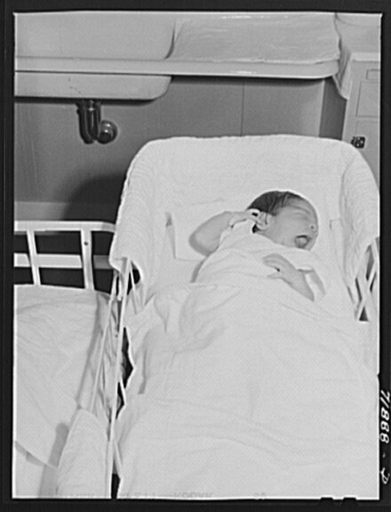 Baby in the nursey at the Cairns General Hospital at the FSA (Farm Security Administration) farm workers' community. Eleven Mile Corner, Arizona 