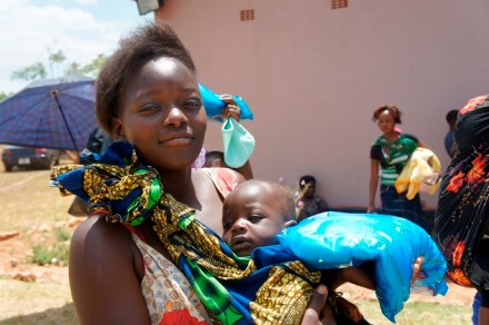 Mother picking up an insecticide treated bed net