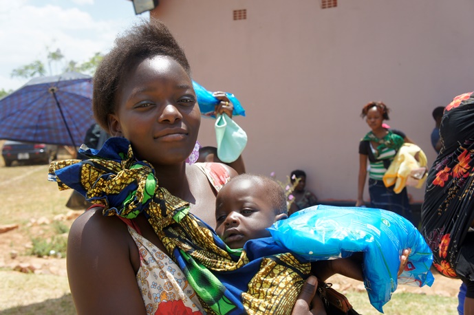 Mother picking up an insecticide treated bed net