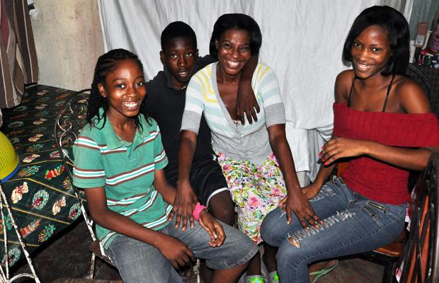 Adeline Eliazard and her three children, Jerry Andrice, Ernst Andrice, and Nadine Andrice (left to right) in their concrete home. (©2014 Jean-Wickens Merlone/World Vision)