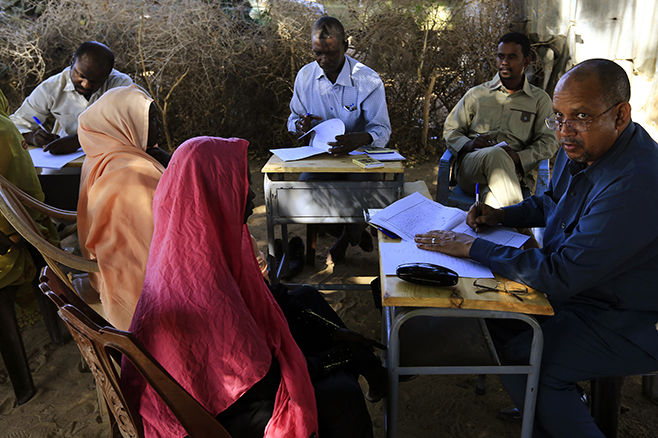 Special Prosecutor for Crimes in Darfur Yasir Ahmed Mohamed (R) and his team talk to women during an investigation into allegations of mass rape in the village of Tabit, in North Darfur, November 20. © 2014 Reuters